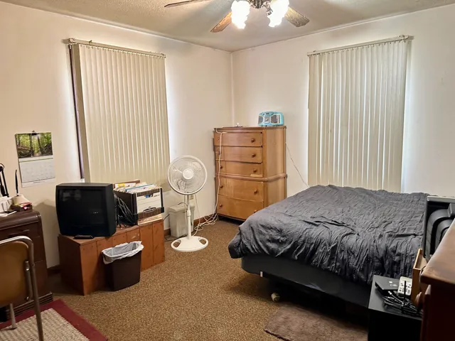 a bedroom with a bed and a couch