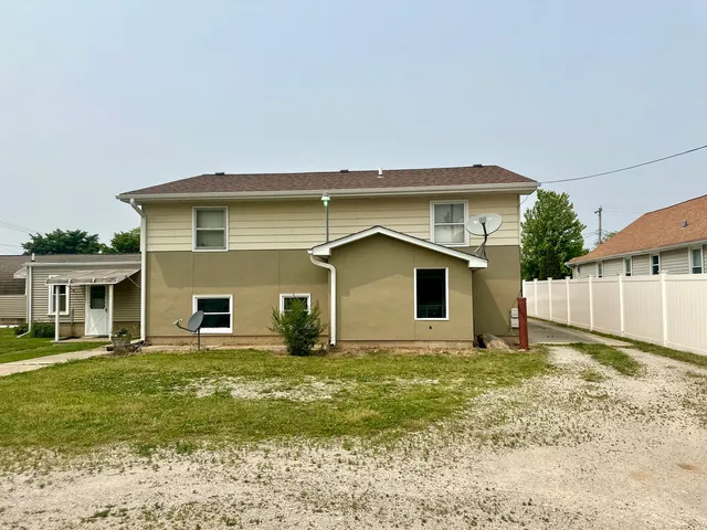a view of a house with a yard and garage