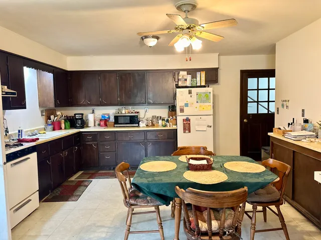 a kitchen with a dining table and chairs