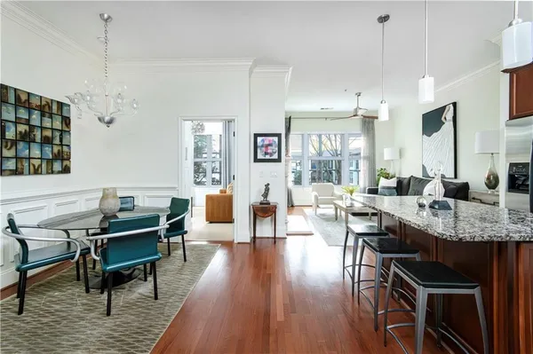 a living room with furniture a wooden floor and chandelier