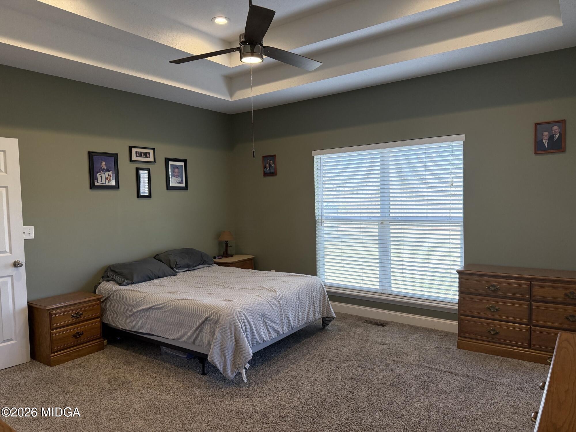 159 Jockey Lane Cochran, GA 31014 - Photo 12 of 39 a bed sitting in a bedroom next to a window