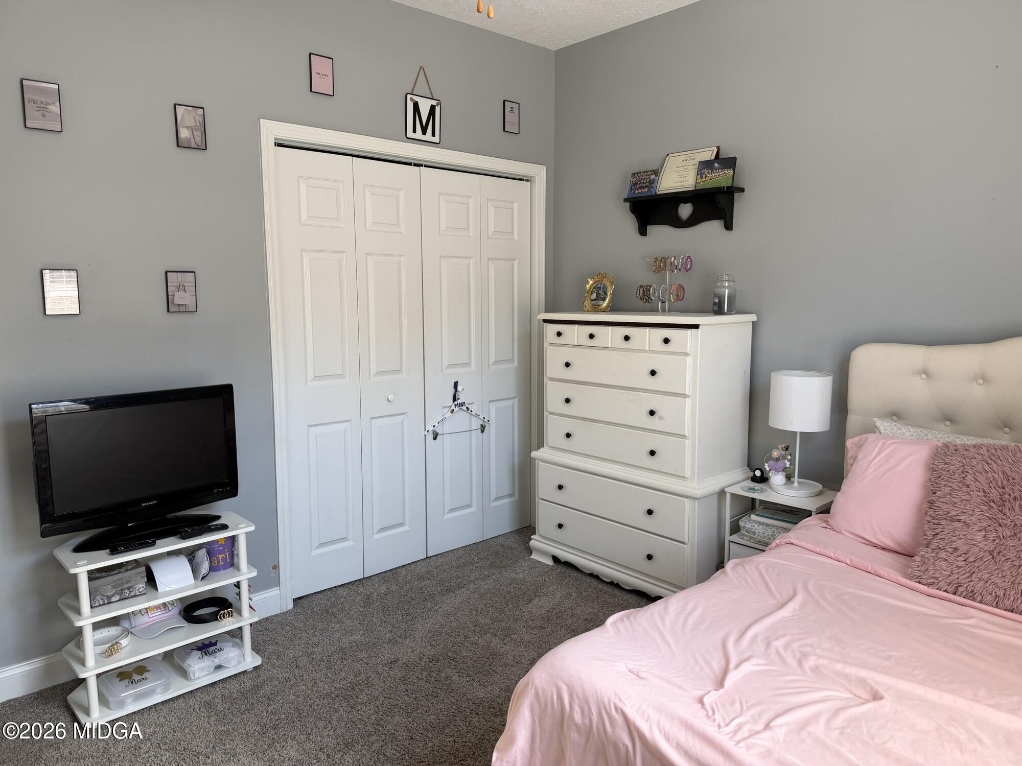 159 Jockey Lane Cochran, GA 31014 - Photo 19 of 39 a bedroom with a bed and a flat tv screen in it