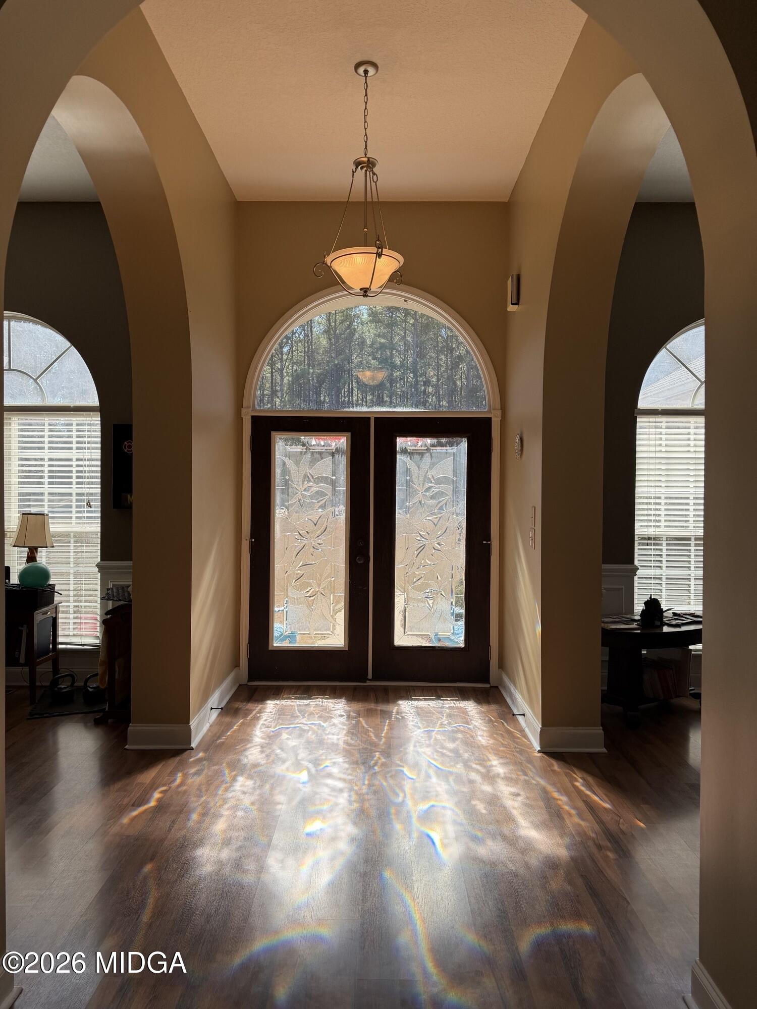 159 Jockey Lane Cochran, GA 31014 - Photo 2 of 39 a view of a big room with windows and chandelier