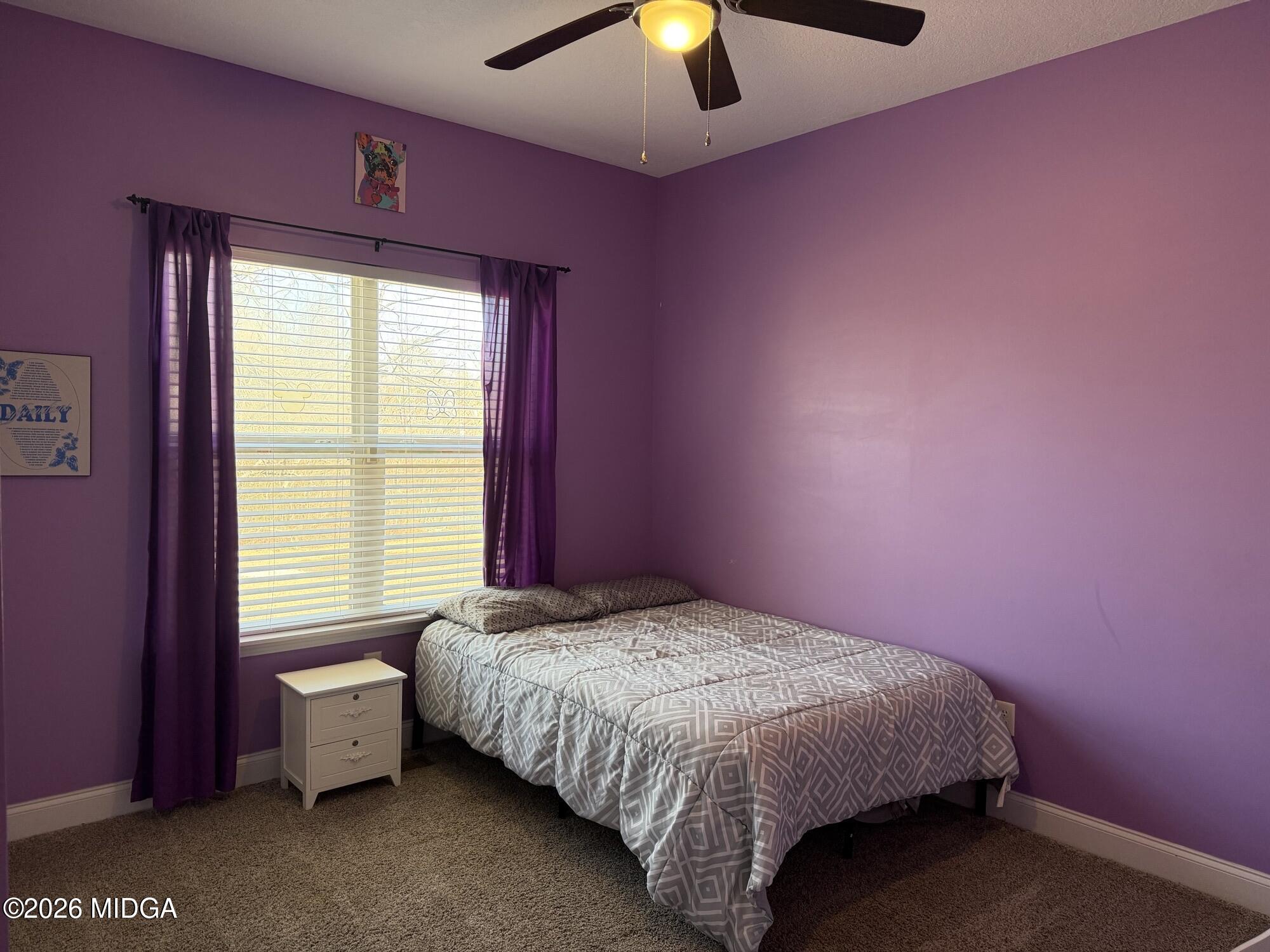 159 Jockey Lane Cochran, GA 31014 - Photo 22 of 39 a bedroom with a bed and a chandelier