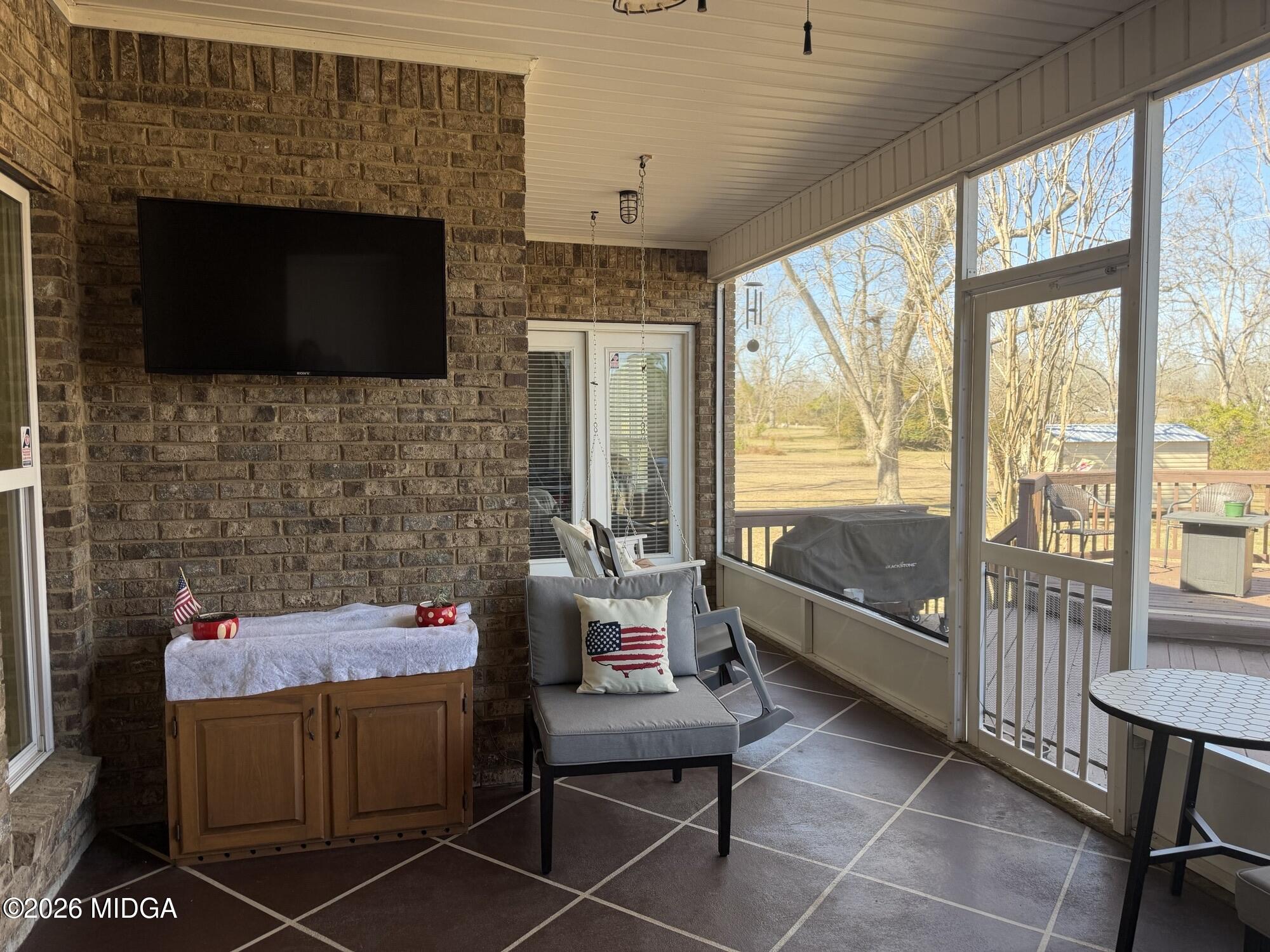 159 Jockey Lane Cochran, GA 31014 - Photo 29 of 39 a living room with furniture a flat screen tv and a fireplace