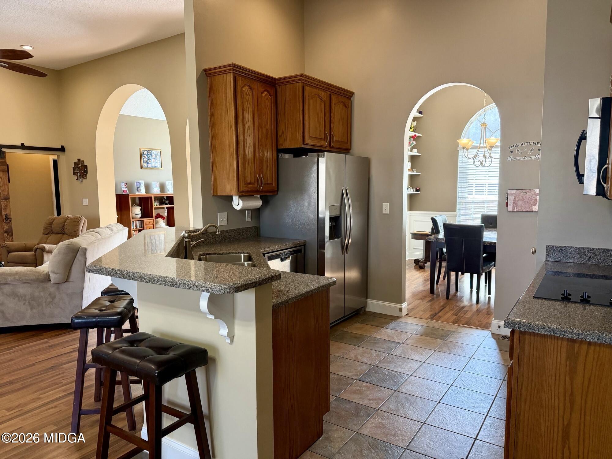 159 Jockey Lane Cochran, GA 31014 - Photo 5 of 39 a kitchen with stainless steel appliances a dining table and chairs