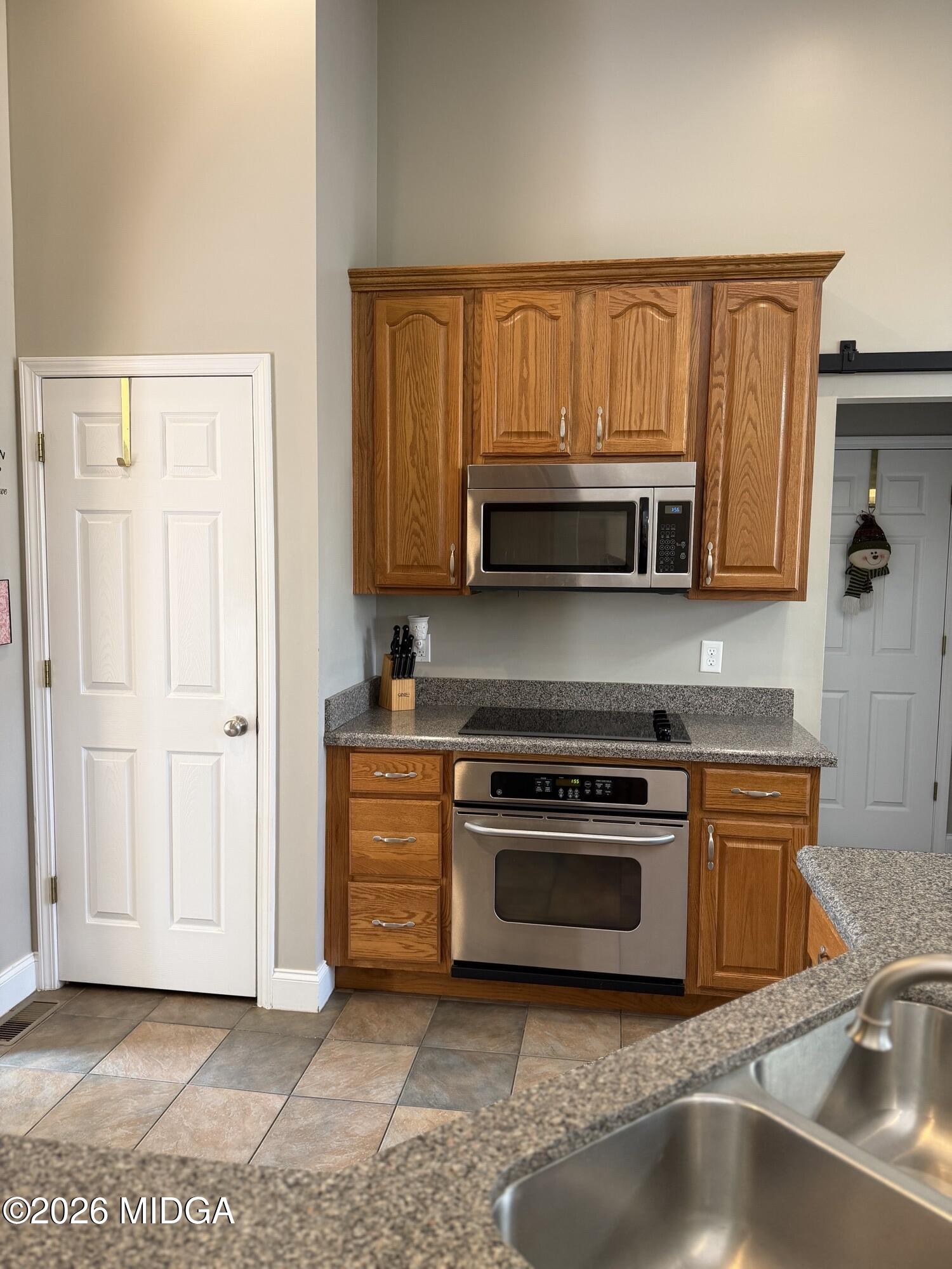 159 Jockey Lane Cochran, GA 31014 - Photo 7 of 39 a kitchen with stainless steel appliances granite countertop a stove a sink and a microwave