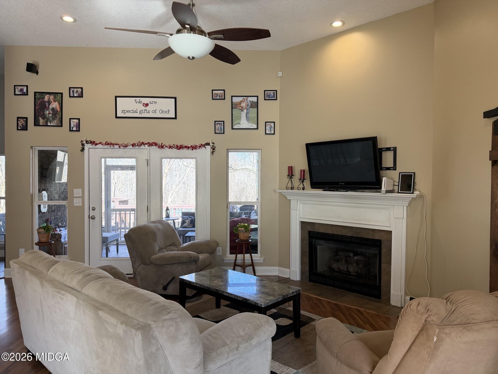 159 Jockey Lane Cochran, GA 31014 - Photo 10 of 39 a living room with furniture a fireplace and a flat screen tv