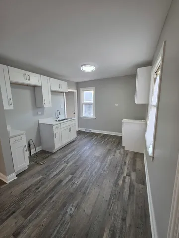 a view of a room with wooden floors and stairs
