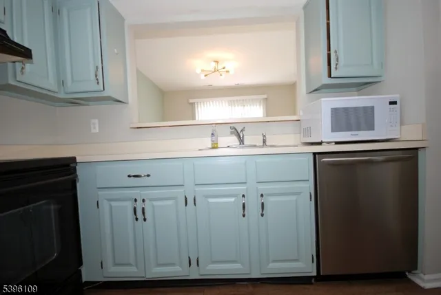 a kitchen with cabinets appliances and a sink
