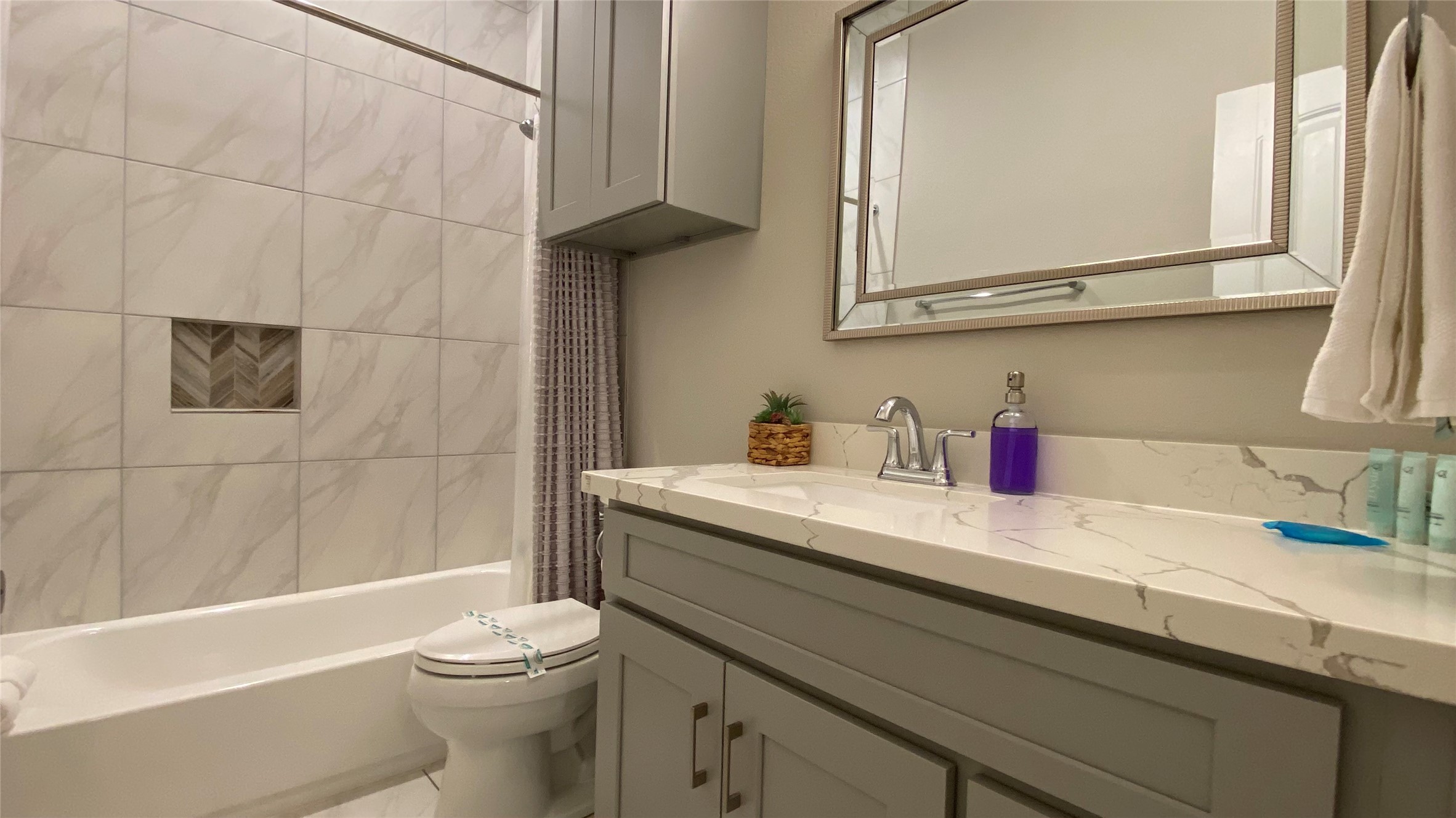 3144 Southmore Boulevard, Unit 4 Houston, TX 77004 - Photo 5 of 10 a bathroom with a granite countertop sink a toilet and bathtub