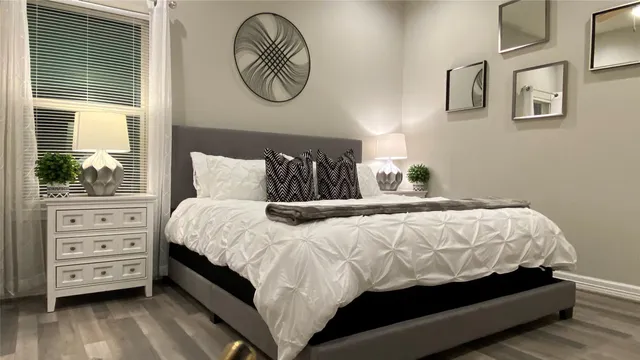 a bedroom with a bed and a window