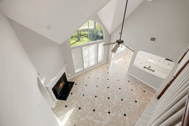 a view of an empty room with a ceiling fan