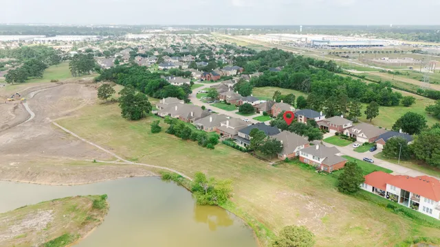 an aerial view of a house with a yard and garden