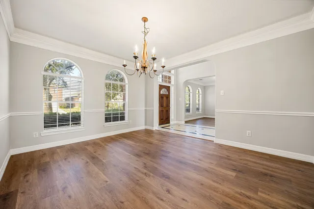 a view of a hallway with a fireplace and chandelier