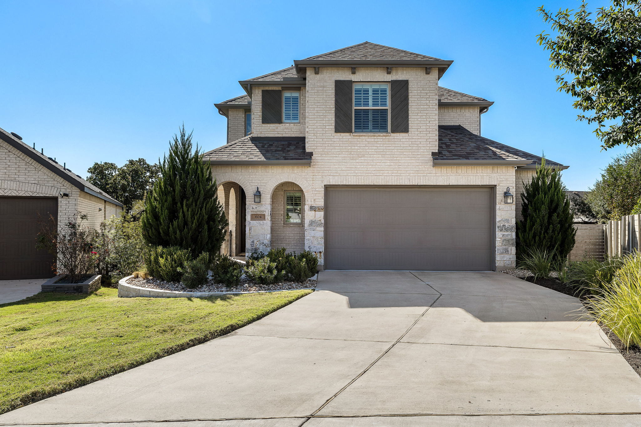 604 Pecan Bottom Trail Georgetown, TX 78628 - Photo 1 of 1 View of front of home with roof with shingles, a garage, brick siding, and concrete driveway