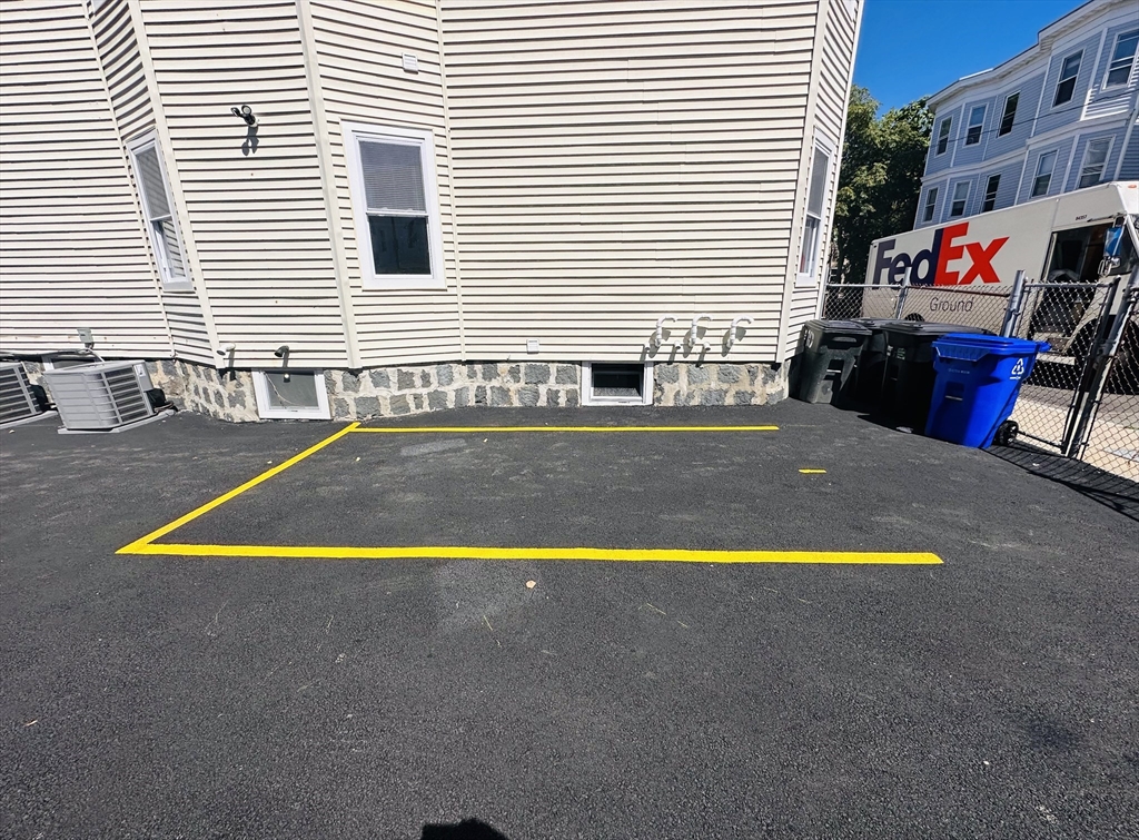 10 Cawfield Street, Unit PARKING Boston, MA 02125 - Photo 2 of 2 a swimming pool with outdoor seating and yard