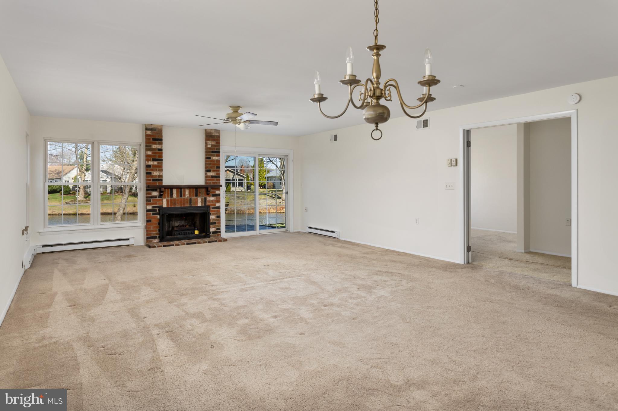 40 Dunstable Road Southampton, NJ 08088 - Photo 7 of 30 en view of a livingroom with furniture a chandelier and a fireplace