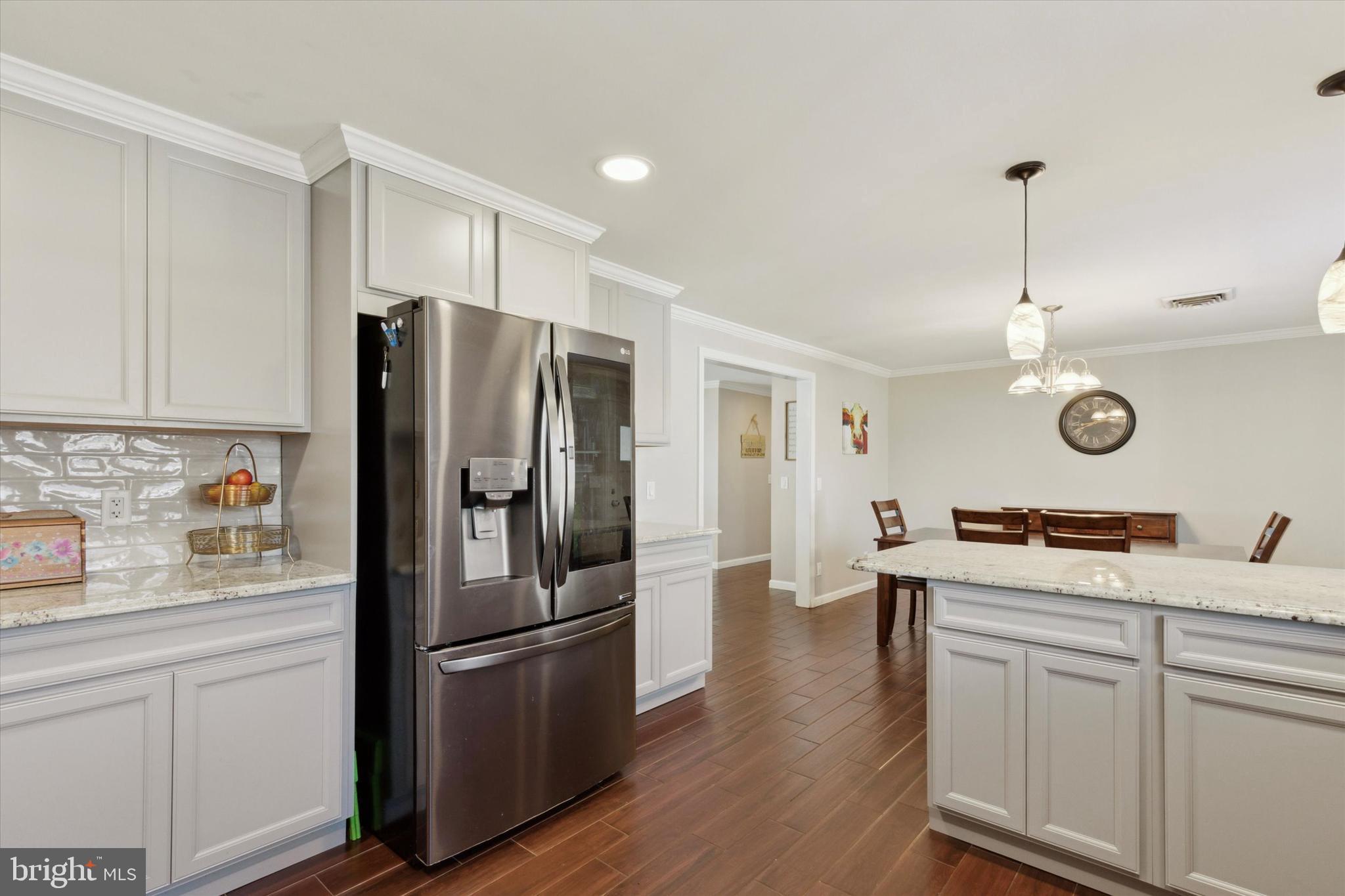 526 Hunsicker Road Telford, PA 18969 - Photo 14 of 35 a kitchen with stainless steel appliances granite countertop a refrigerator a stove a sink and white cabinets with wooden floor