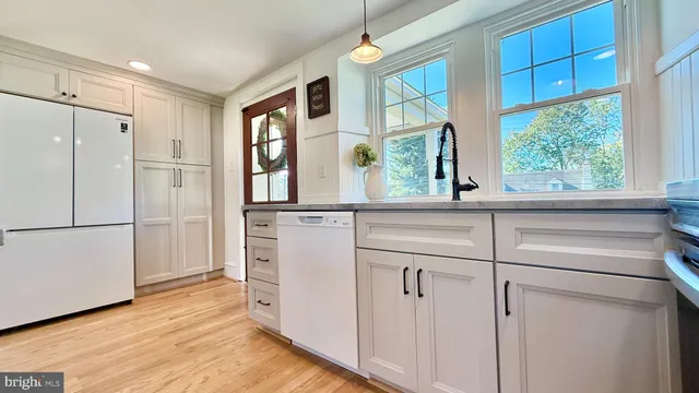 a stove top oven sitting inside of a kitchen