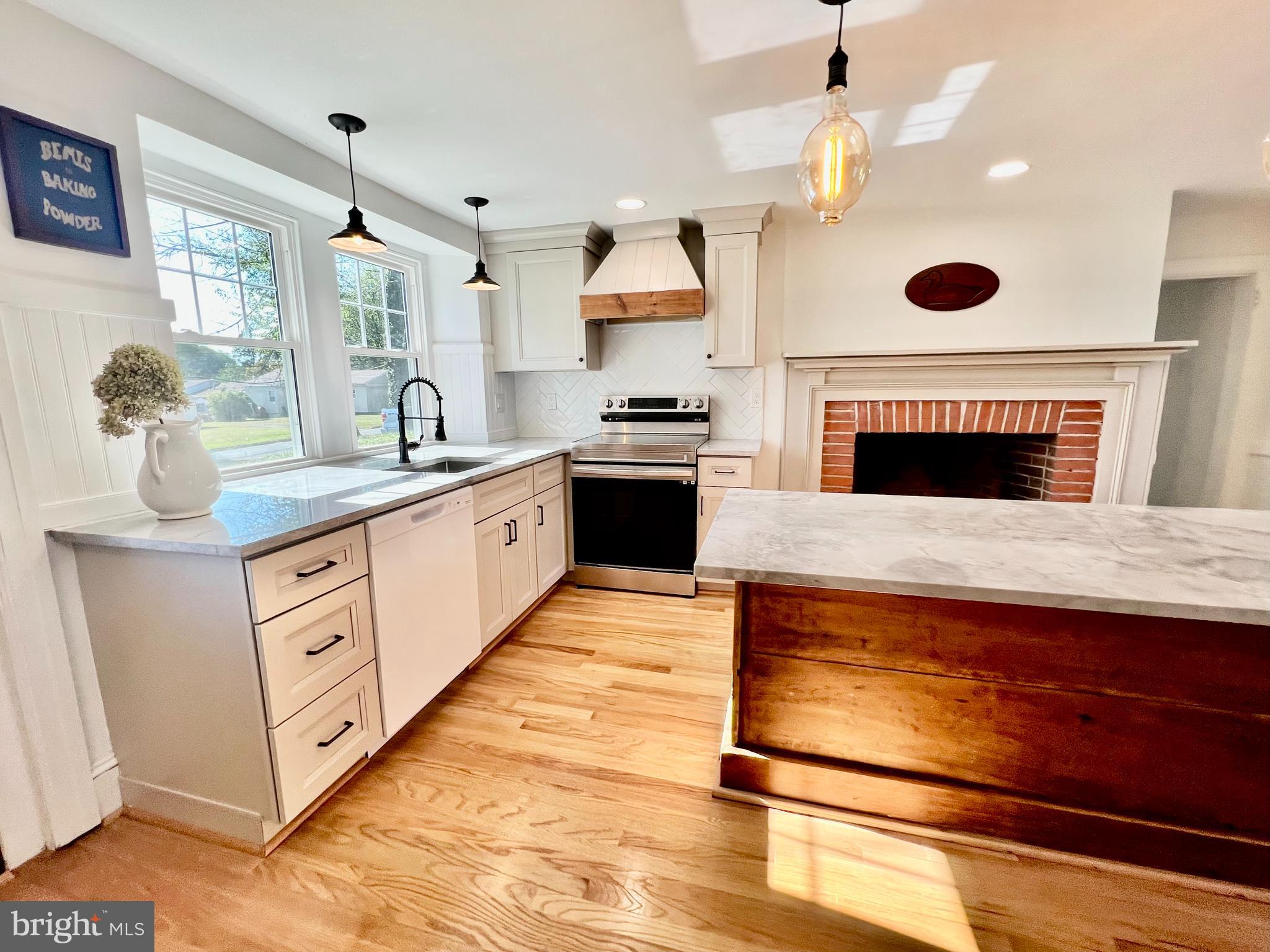2437 Patane Avenue Abington, PA 19001 - Photo 13 of 69 a kitchen with stainless steel appliances granite countertop a stove and a wooden floors