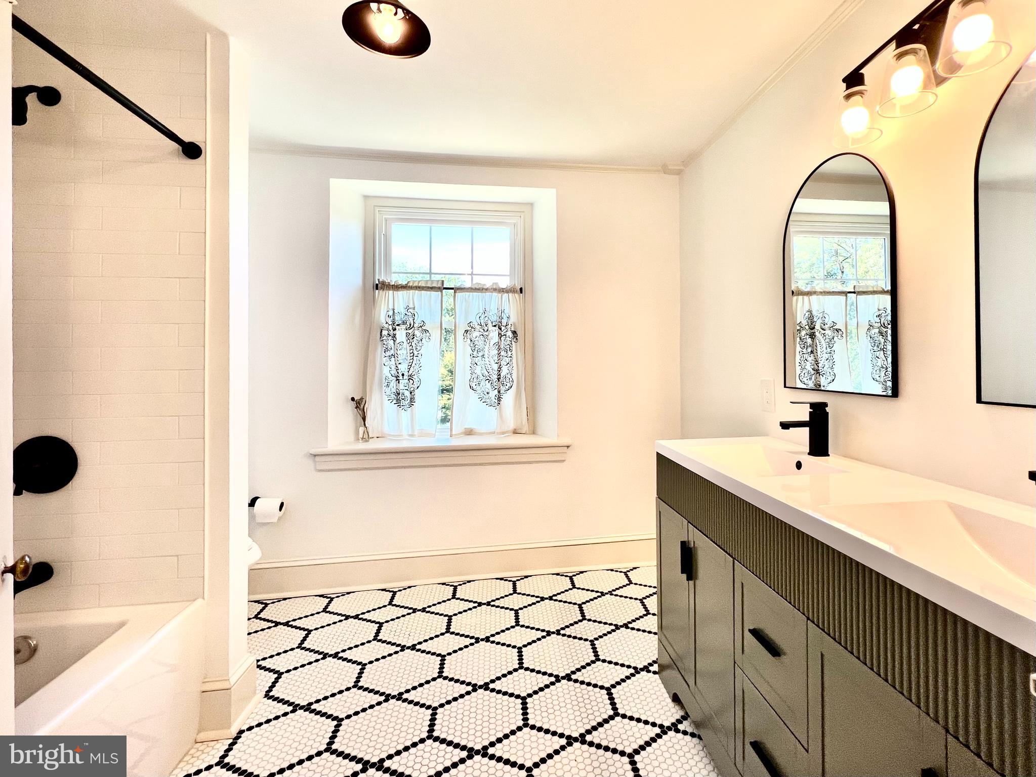2437 Patane Avenue Abington, PA 19001 - Photo 30 of 69 a bathroom with a sink a vanity and a mirror