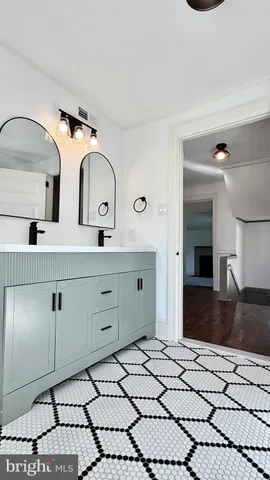 a view of empty room with wooden floor and fireplace