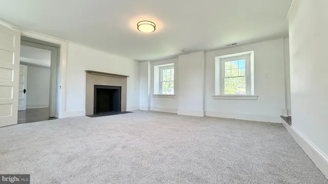 a view of an empty room with a ceiling fan