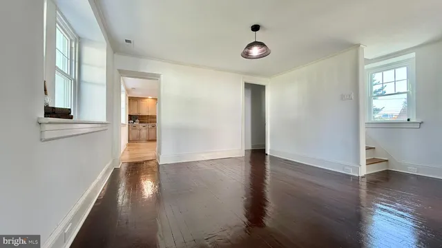 a large kitchen with cabinets appliances and a window