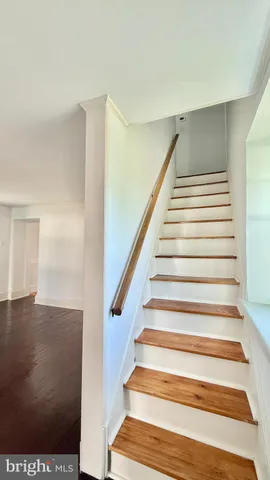 a large kitchen with stainless steel appliances granite countertop a stove refrigerator and cabinets