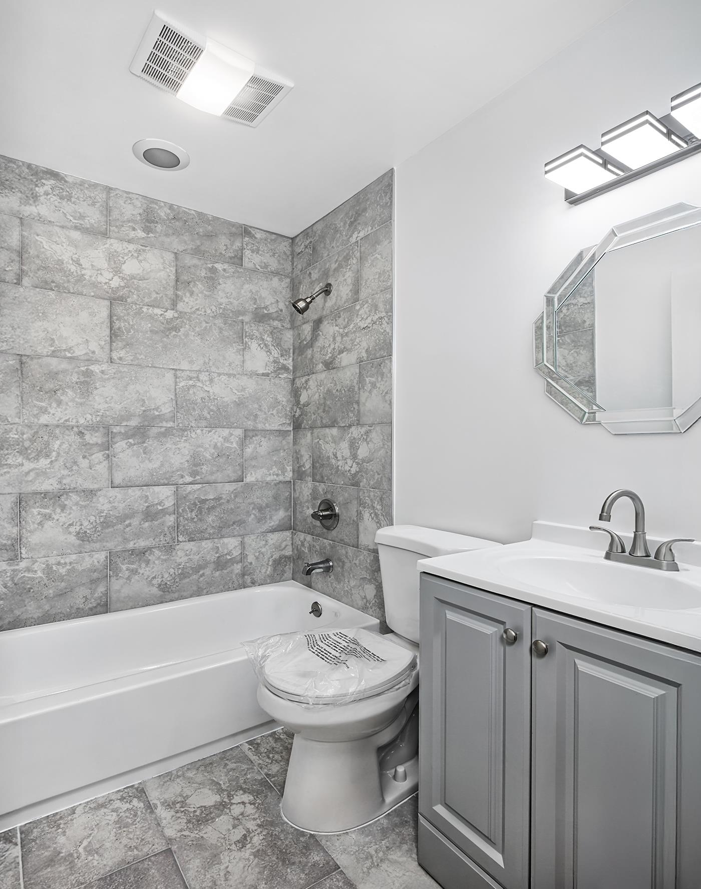 9 Madison Avenue, Unit 18 Paterson, NJ 07524 - Photo 10 of 18 a bathroom with a sink a toilet and bathtub