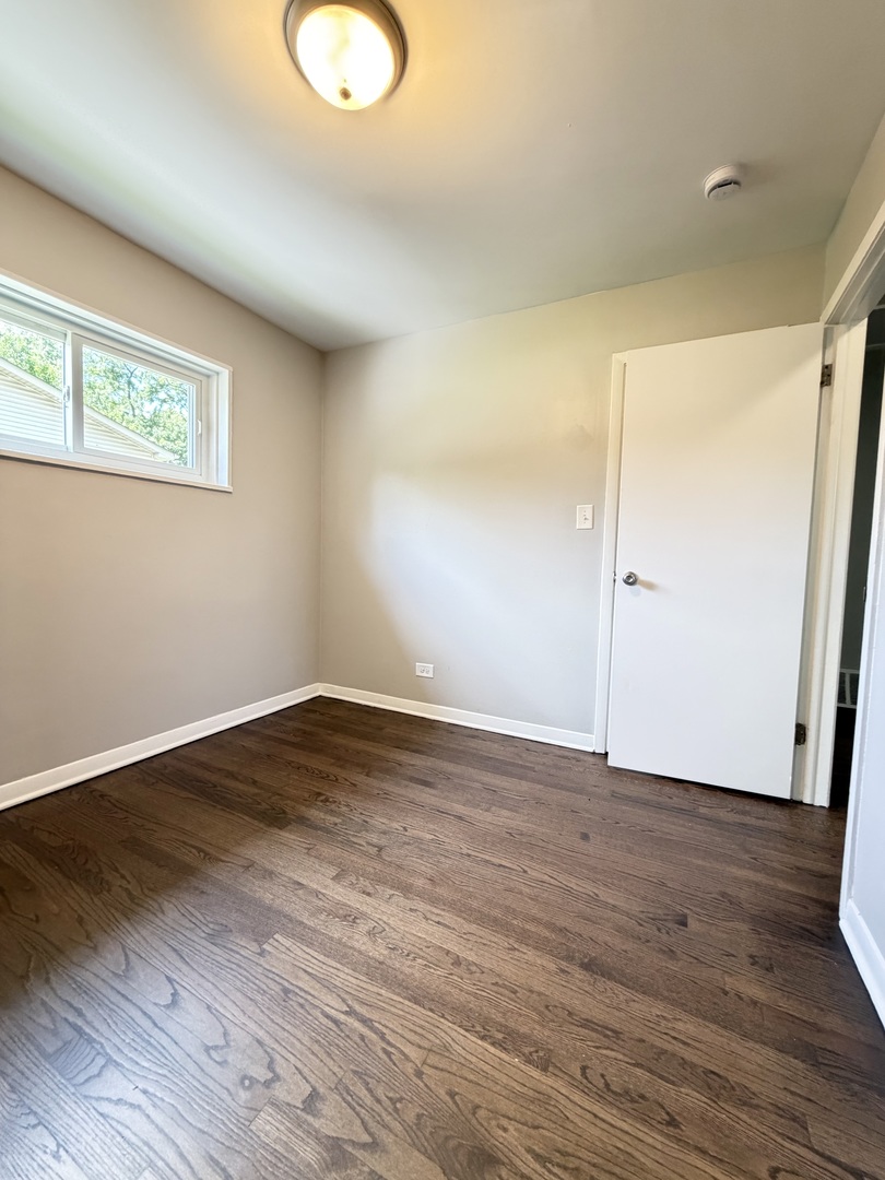 1820 169th Street Hazel Crest, IL 60429 - Photo 19 of 23 an empty room with wooden floor and windows