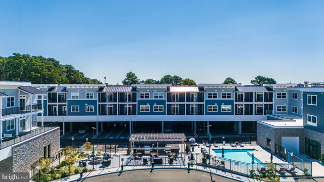 a view of a patio with couches table and chairs and potted plants