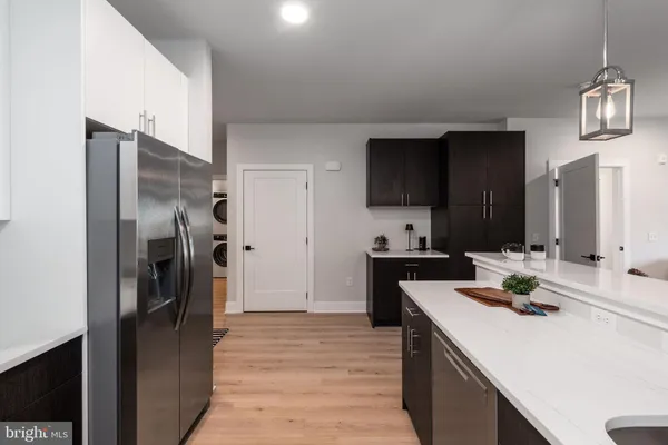 a view of a kitchen counter top space a sink and living room view