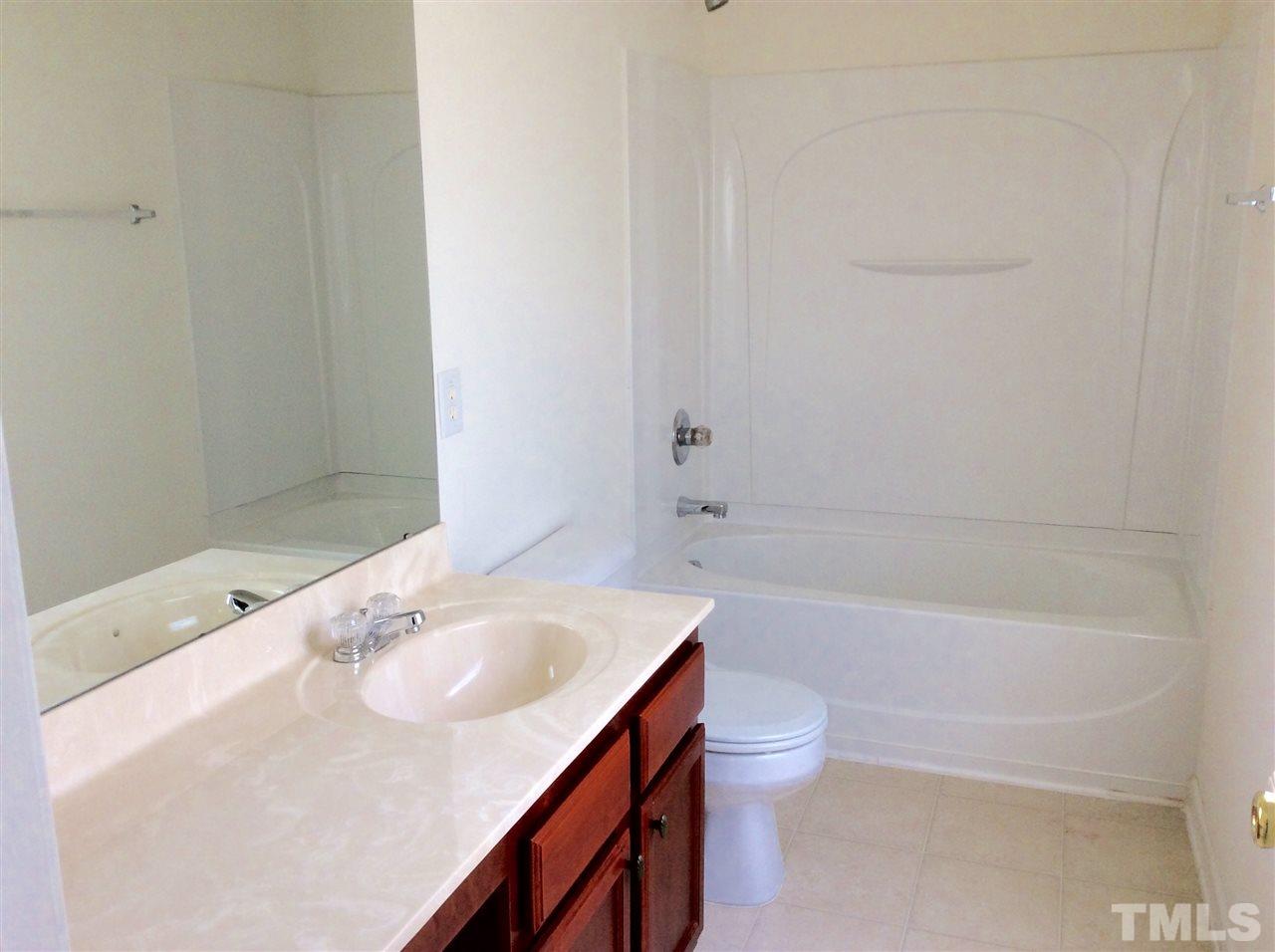 3729 Marshlane Way Raleigh, NC 27610 - Photo 15 of 16 a bathroom with a sink a toilet and shower