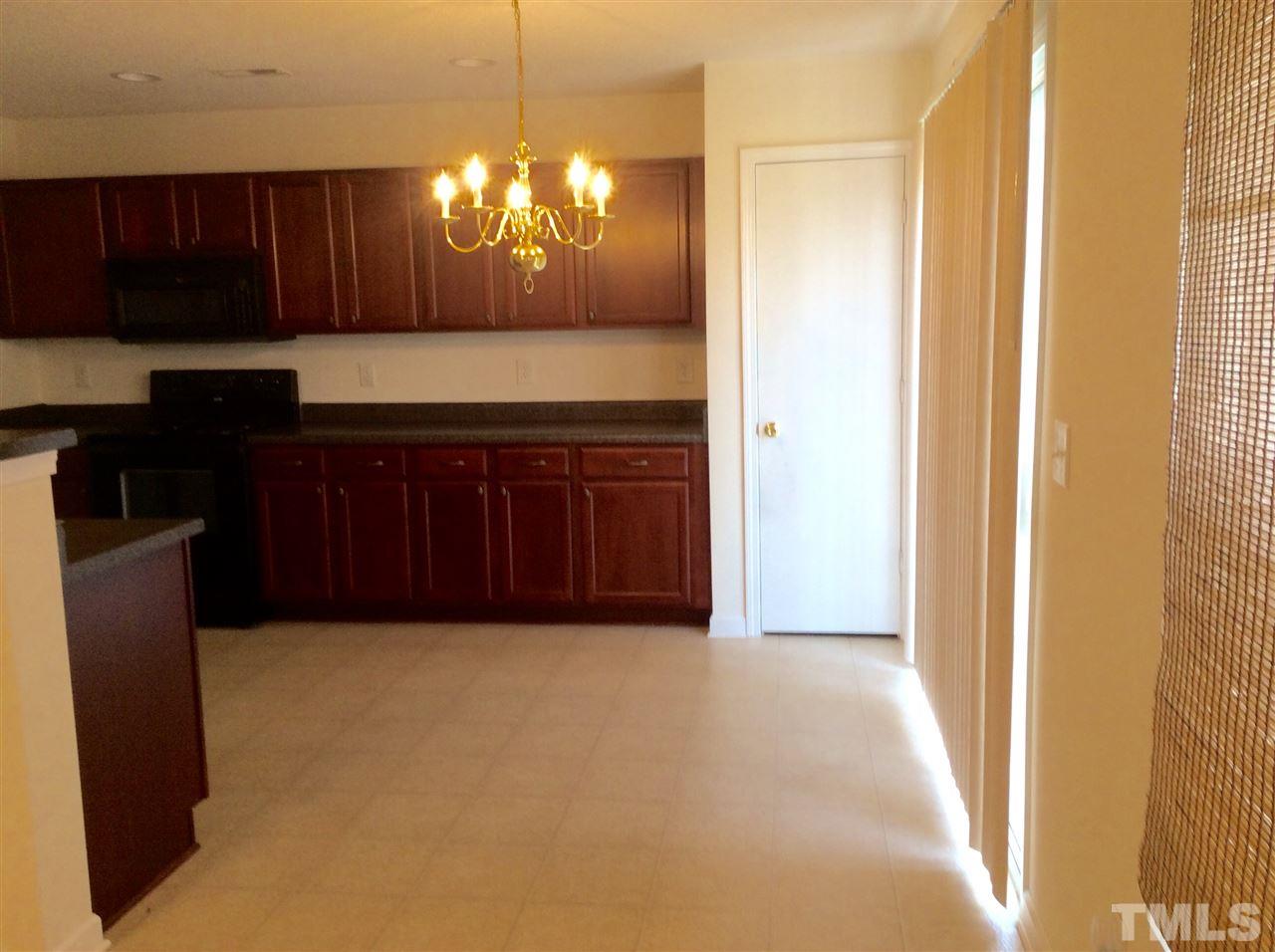 3729 Marshlane Way Raleigh, NC 27610 - Photo 5 of 16 a kitchen with a sink and a refrigerator
