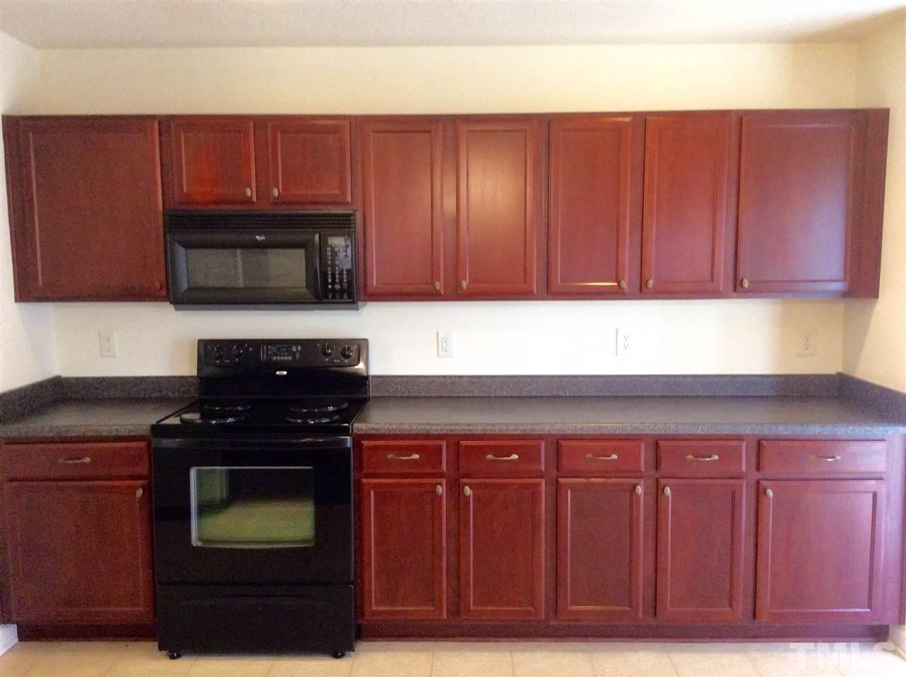 3729 Marshlane Way Raleigh, NC 27610 - Photo 6 of 16 a kitchen with wooden cabinets and a stove top oven