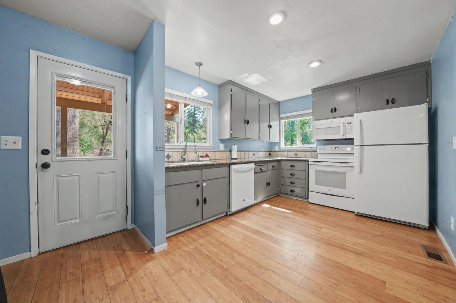 19479 Murphy Road Pine Grove, CA 95665 - Photo 11 of 43 a kitchen with white cabinets and white appliances