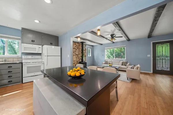 a kitchen with white cabinets and white appliances