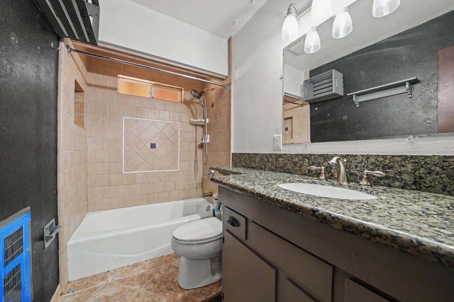 19479 Murphy Road Pine Grove, CA 95665 - Photo 24 of 43 a bathroom with a granite countertop sink a toilet and bathtub