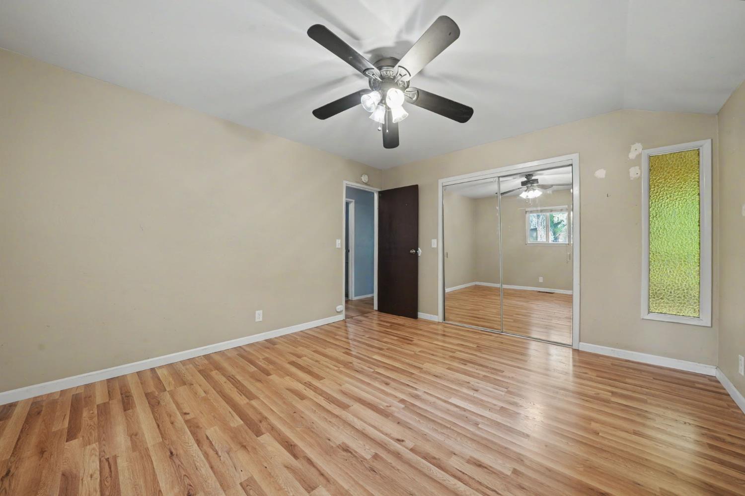 19479 Murphy Road Pine Grove, CA 95665 - Photo 29 of 43 a view of an empty room with wooden floor and a ceiling fan