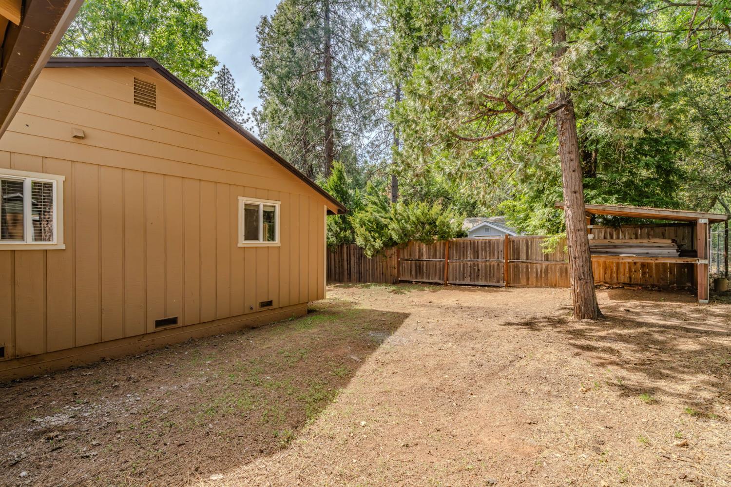 19479 Murphy Road Pine Grove, CA 95665 - Photo 40 of 43 a backyard of a house with garage and barbeque oven
