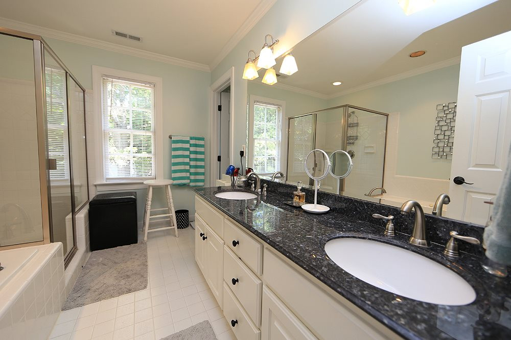 9101 Tealby Place Raleigh, NC 27615 - Photo 19 of 30 Private bath for 2nd master with white cabinets, dual vanities, granite tops, whirlpool tub, separate shower, private water closet and tile floors. Bathroom