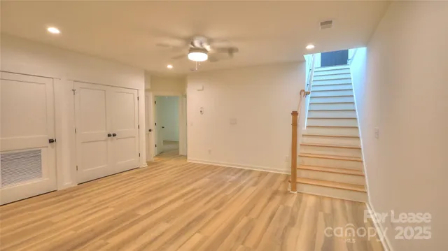 a view of a room with wooden floor