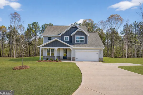 a front view of a house with a yard and garage