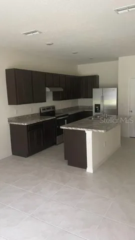 a kitchen with stainless steel appliances a stove a sink and a microwave
