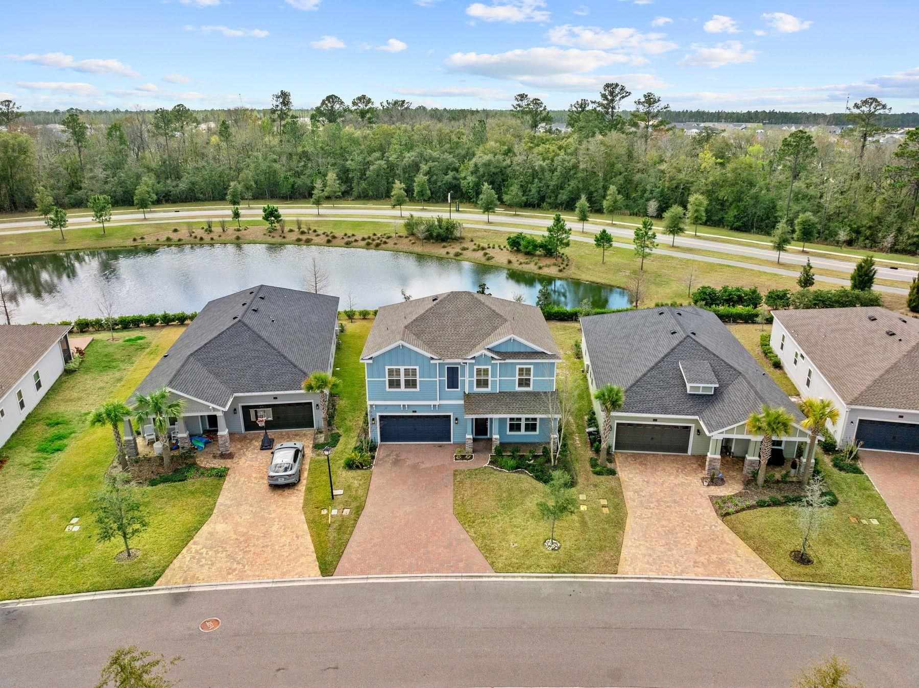 an aerial view of a house with pool lake view and mountain view