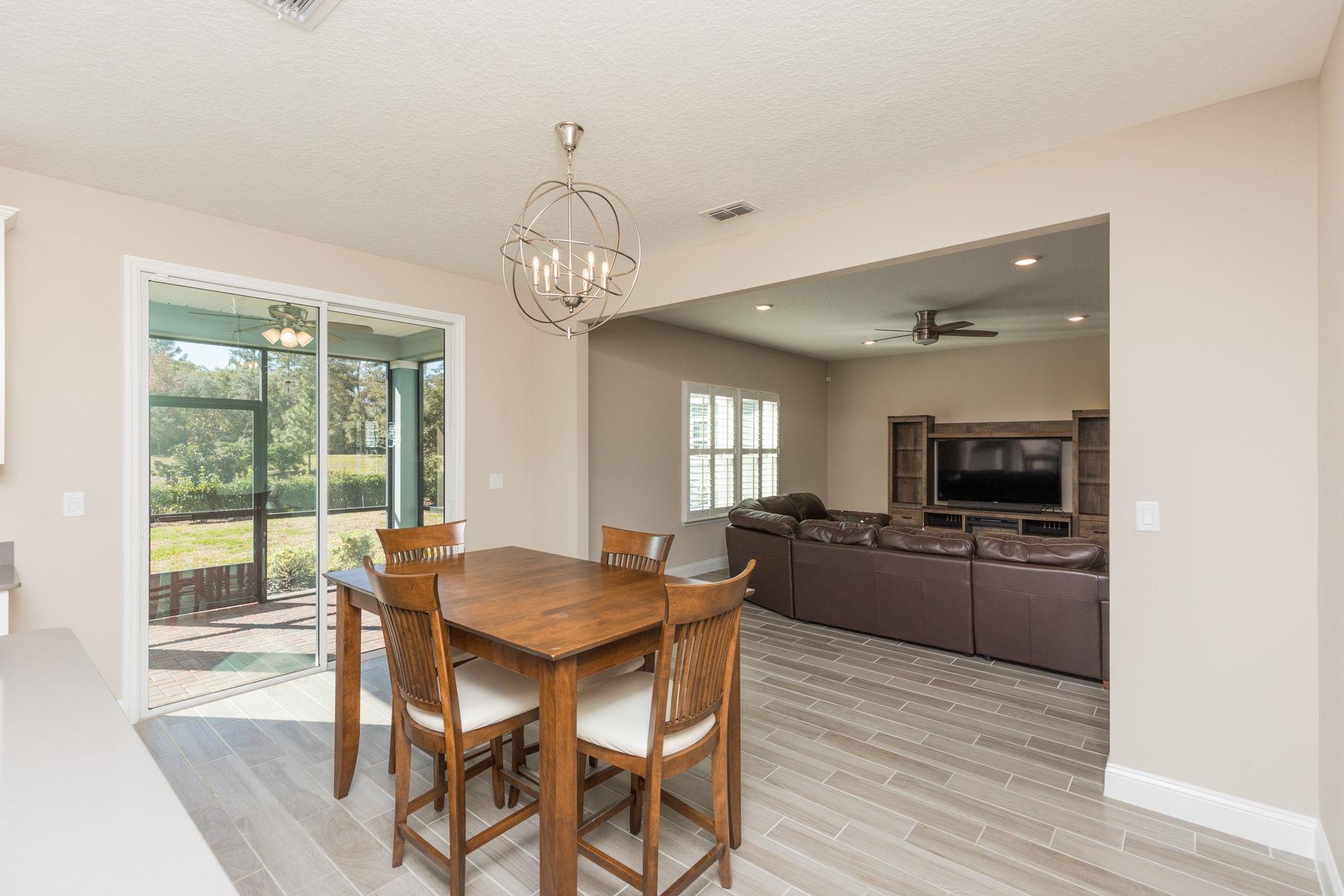 91 Ridgewind Drive St. Augustine, FL 32092 - Photo 14 of 49 a view of a dining room with furniture wooden floor and chandelier