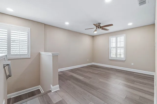 a spacious bathroom with double vanity and mirrors