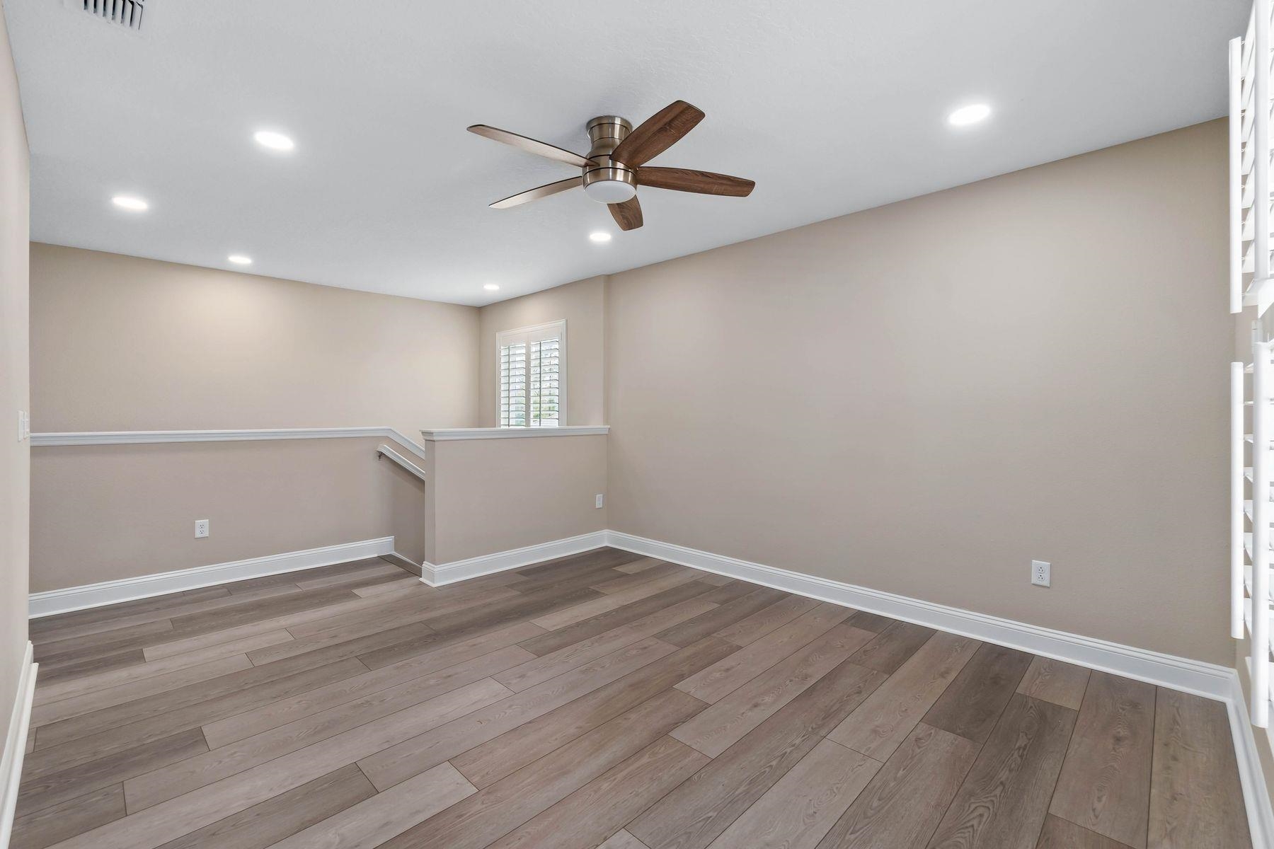 91 Ridgewind Drive St. Augustine, FL 32092 - Photo 19 of 49 an empty room with wooden floor fan and windows
